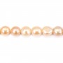 Salmon color oval freshwater pearls on thread 13-15mm x 40cm